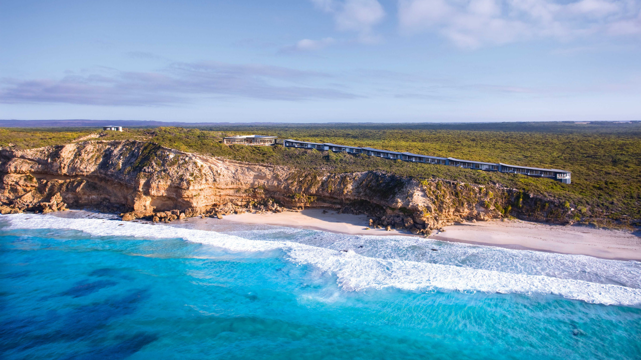 Green and Brown Mountain Beside Blue Sea Under Blue Sky During Daytime. Wallpaper in 1280x720 Resolution