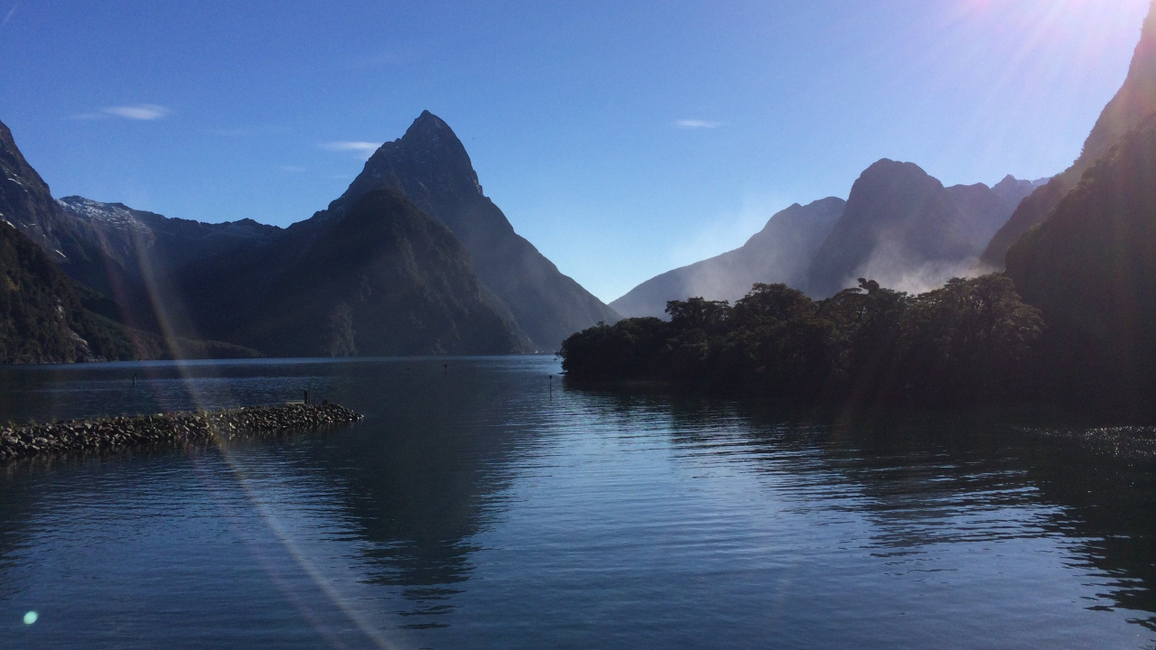 Body of Water Near Mountain Under Blue Sky During Daytime. Wallpaper in 1280x720 Resolution