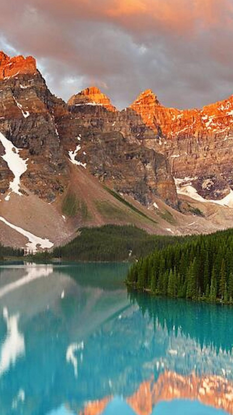 Lake Near Mountain Under Blue Sky During Daytime. Wallpaper in 750x1334 Resolution