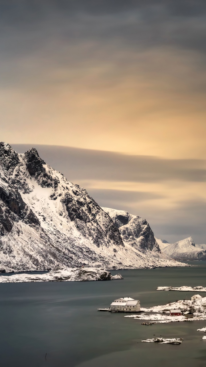 Snow Covered Mountain Near Body of Water During Daytime. Wallpaper in 720x1280 Resolution