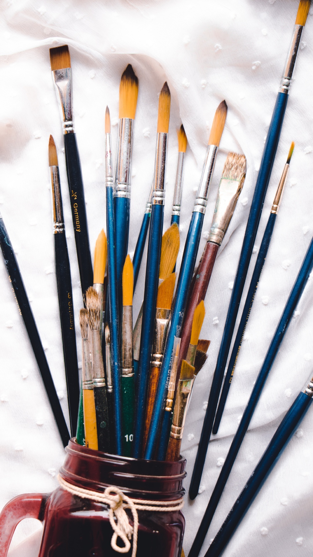 Assorted Color Paint Brushes on White Textile. Wallpaper in 1080x1920 Resolution
