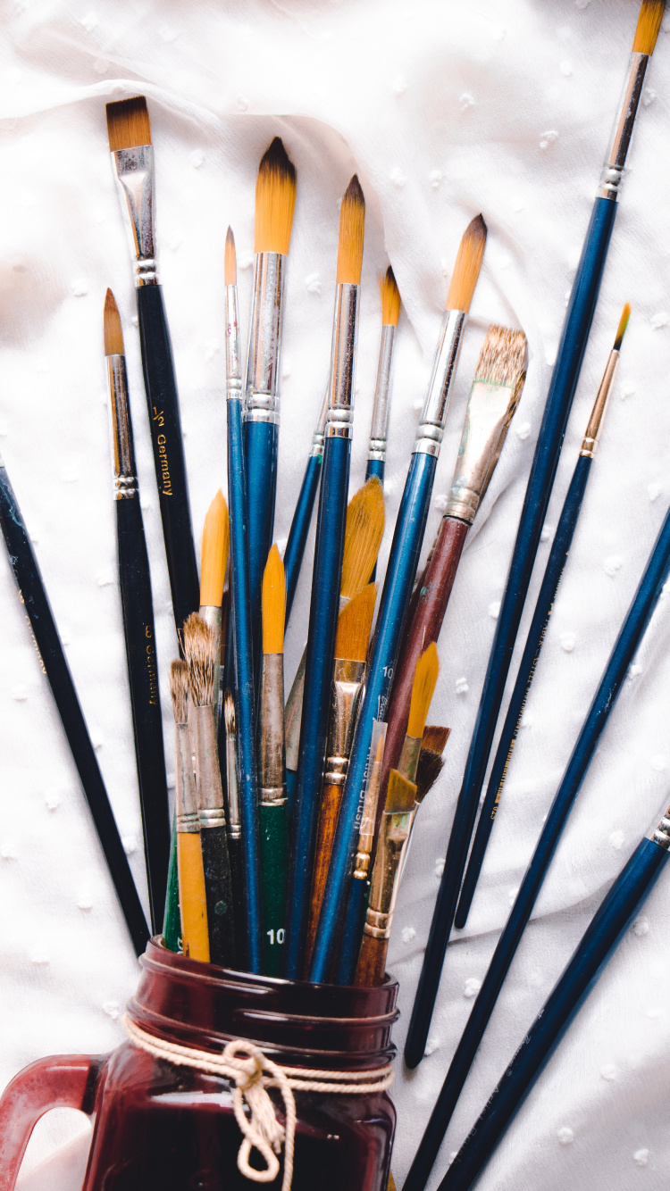 Assorted Color Paint Brushes on White Textile. Wallpaper in 750x1334 Resolution
