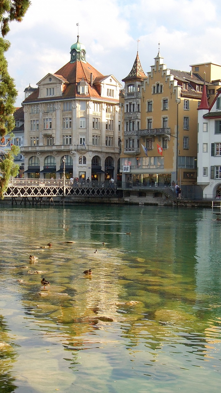 Body of Water Near Green Trees and White Concrete Building During Daytime. Wallpaper in 720x1280 Resolution