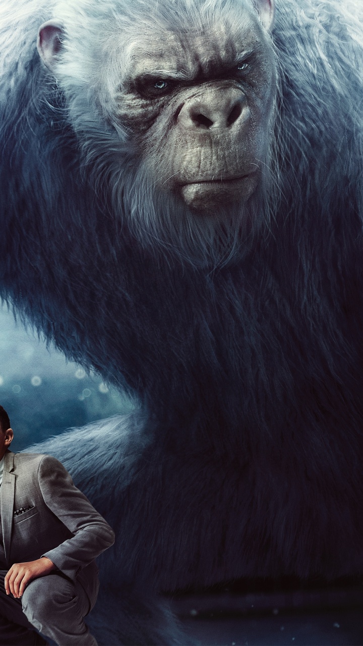 Hombre Con Chaqueta Negra y Gorra Negra Sentada Sobre Roca Gris. Wallpaper in 720x1280 Resolution