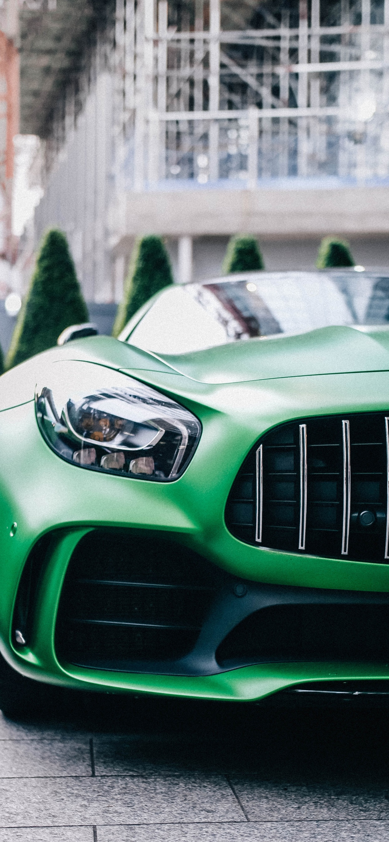 Green Car With White and Black Car on The Side. Wallpaper in 1242x2688 Resolution
