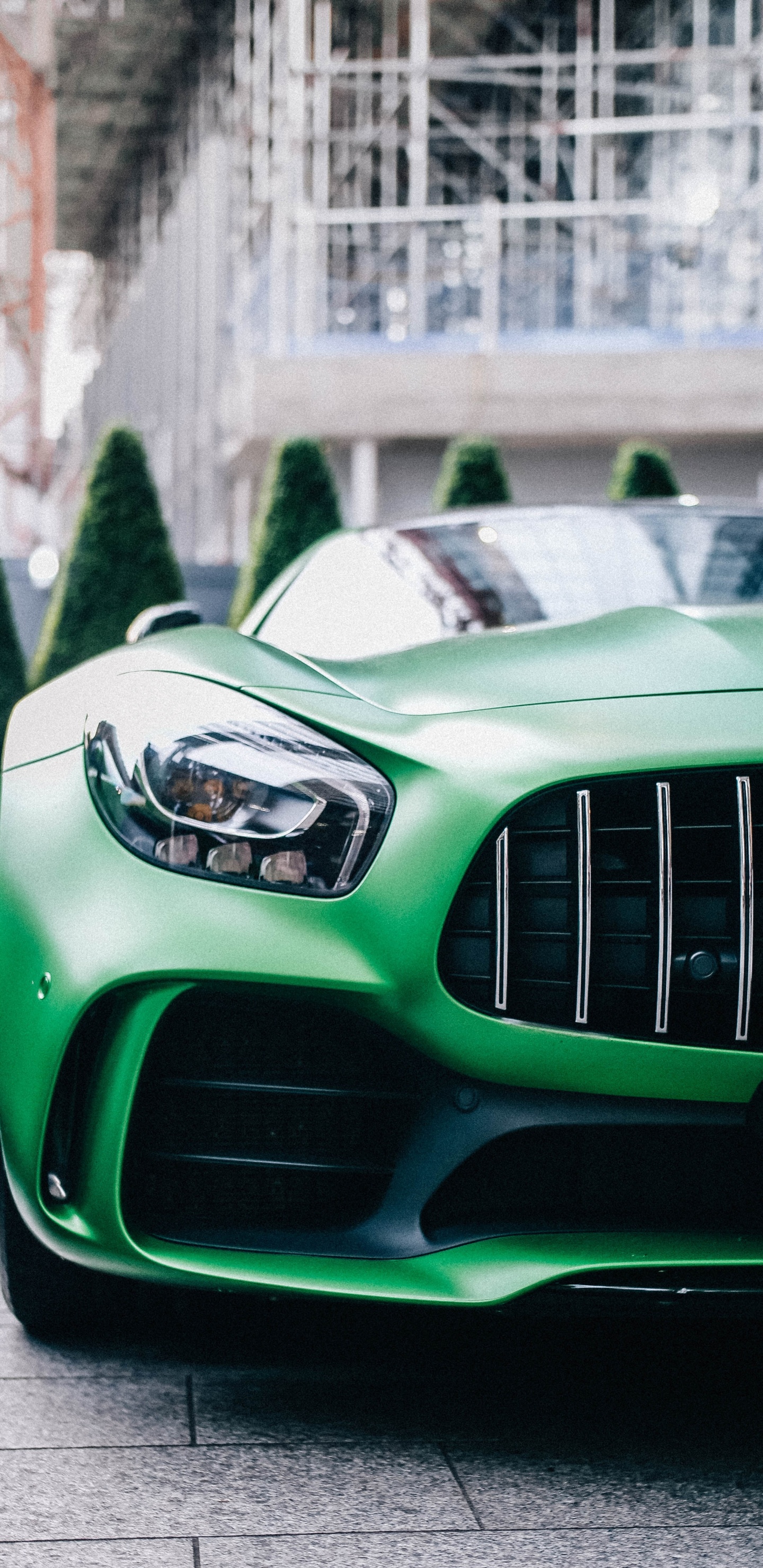 Green Car With White and Black Car on The Side. Wallpaper in 1440x2960 Resolution