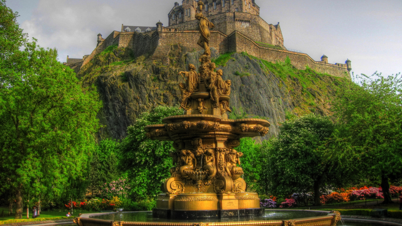 Brown Concrete Fountain Near Green Trees Under White Clouds During Daytime. Wallpaper in 1366x768 Resolution