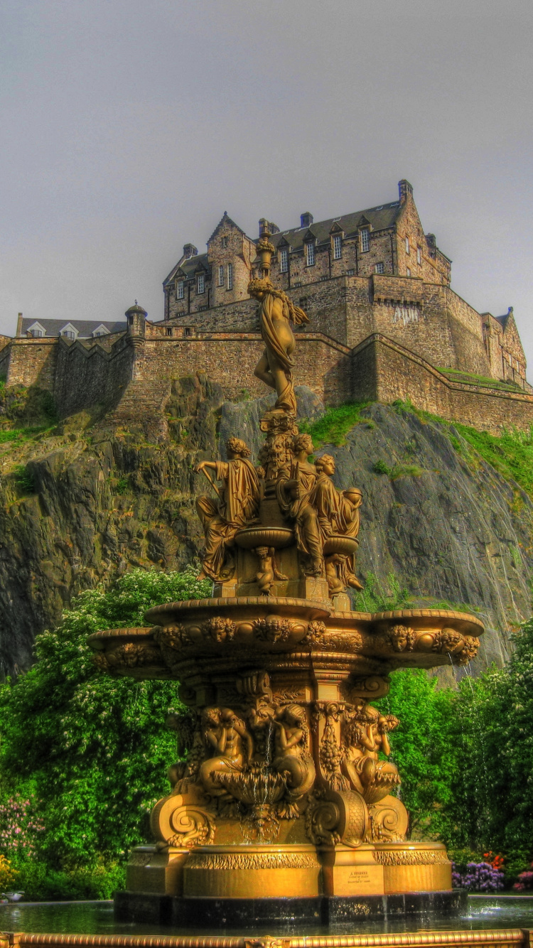 Brown Concrete Fountain Near Green Trees Under White Clouds During Daytime. Wallpaper in 750x1334 Resolution