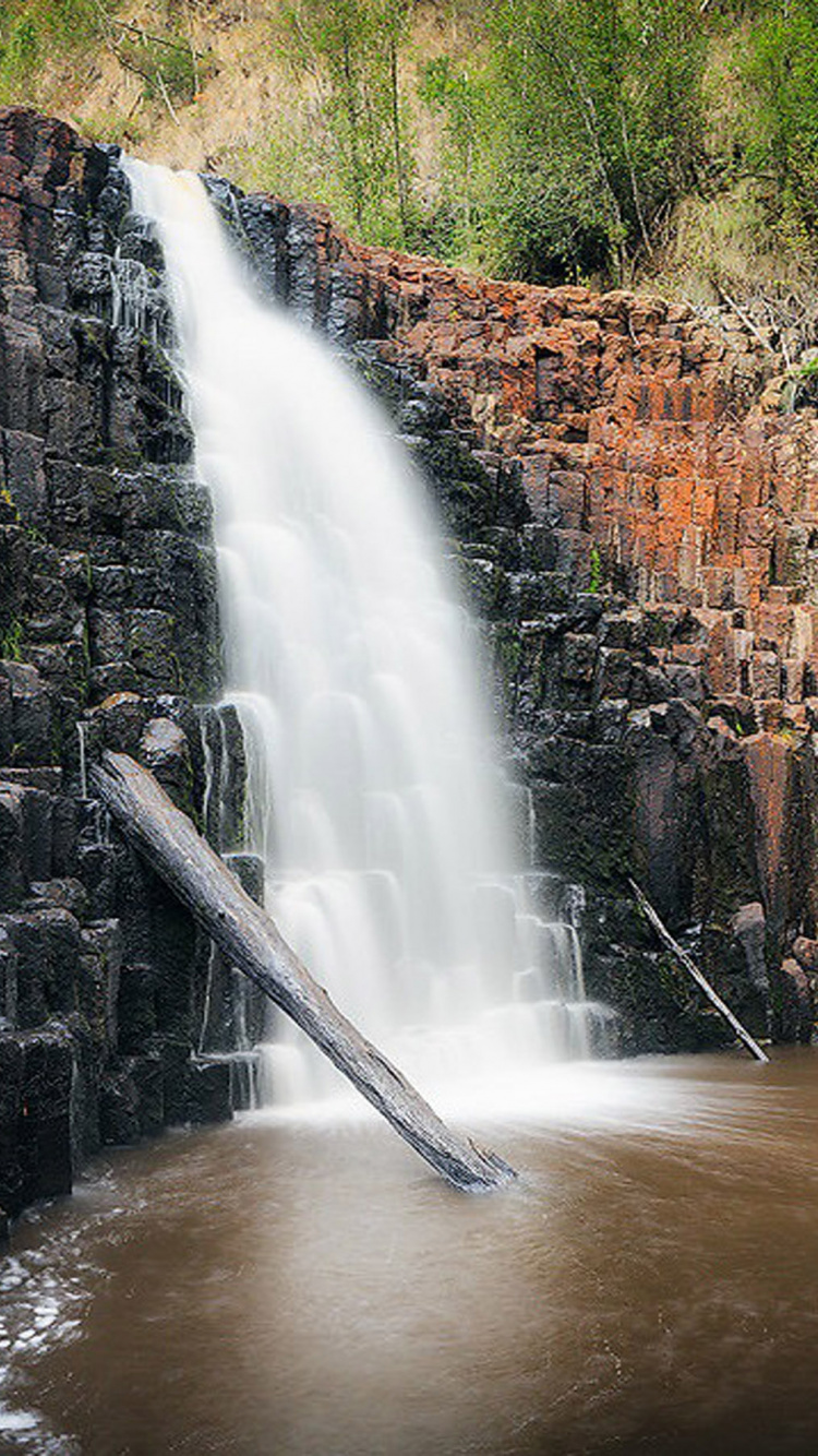 Water Falls on Brown Rocky Mountain. Wallpaper in 750x1334 Resolution