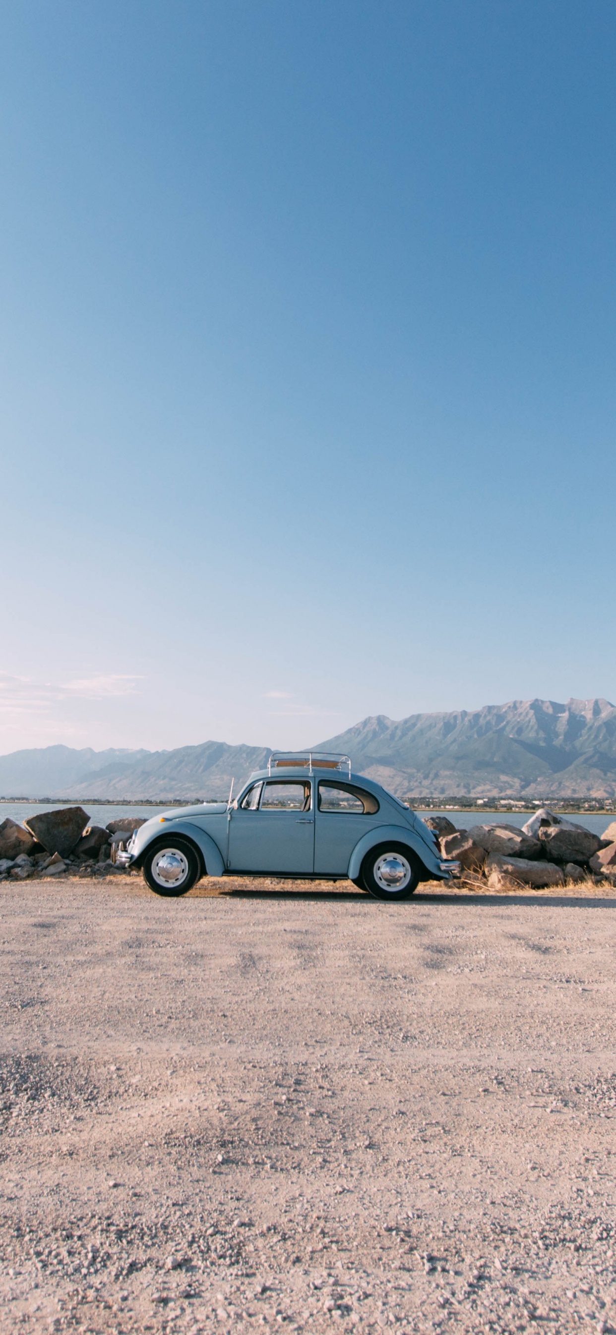 Blue Car on Brown Sand During Daytime. Wallpaper in 1242x2688 Resolution