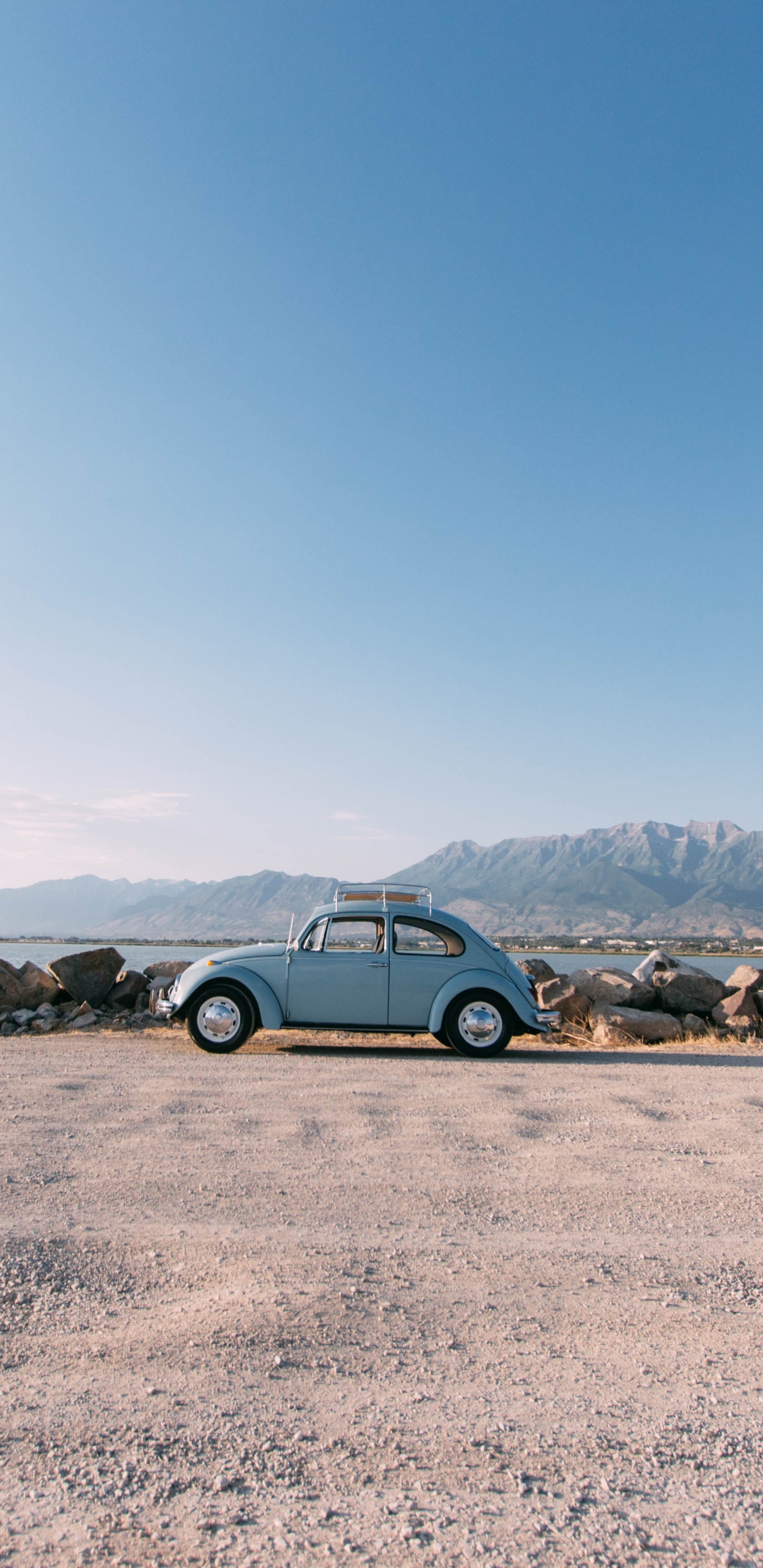 Blue Car on Brown Sand During Daytime. Wallpaper in 1440x2960 Resolution