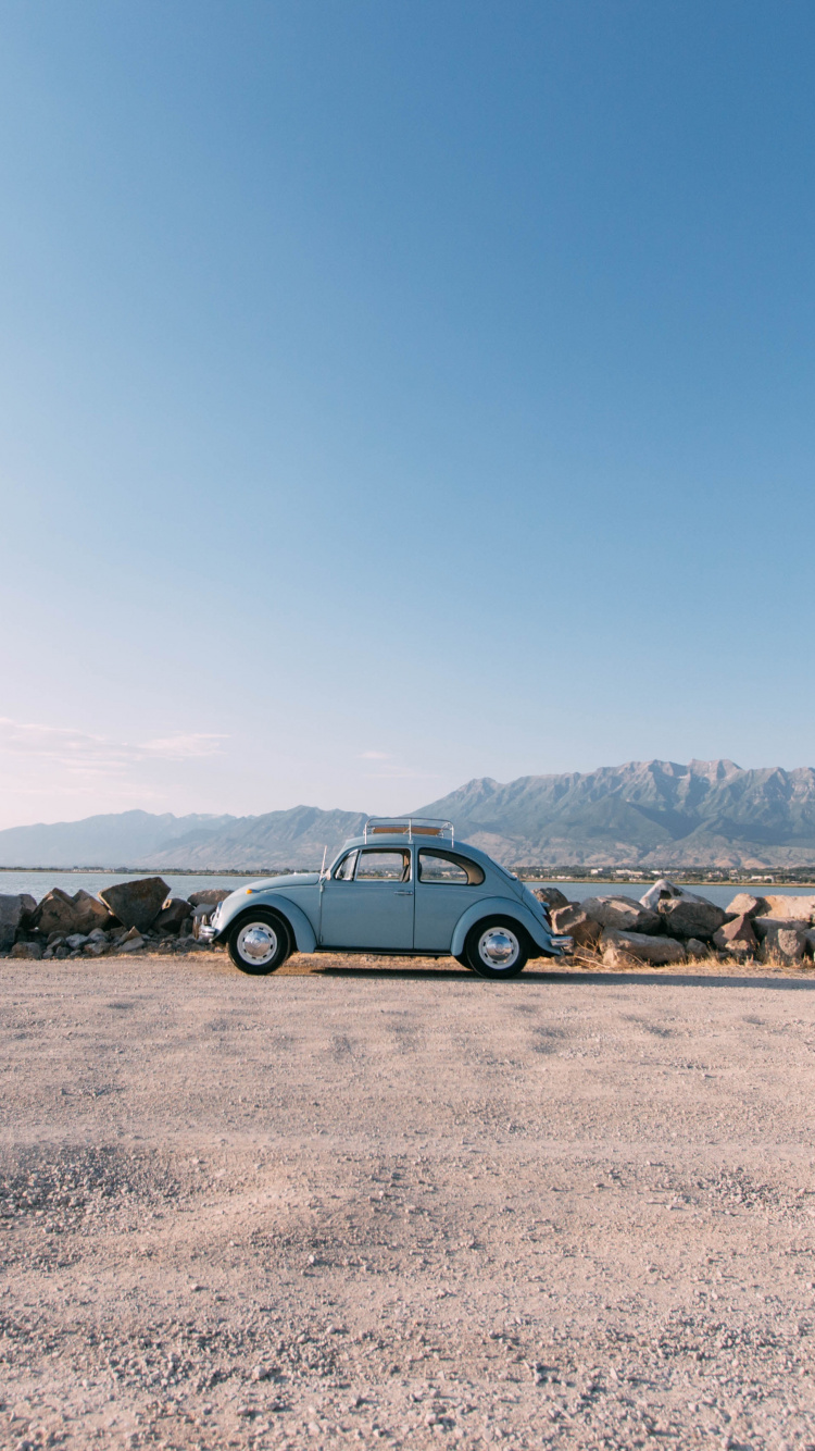 Blue Car on Brown Sand During Daytime. Wallpaper in 750x1334 Resolution
