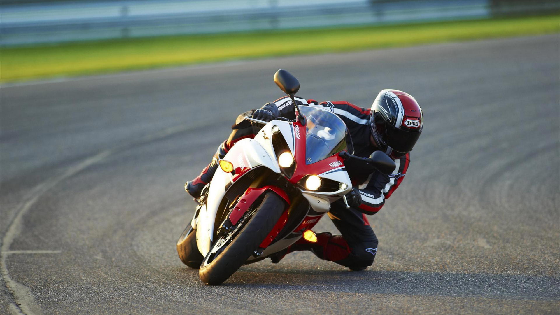 Man in Black and Red Motorcycle Suit Riding on Sports Bike. Wallpaper in 1920x1080 Resolution