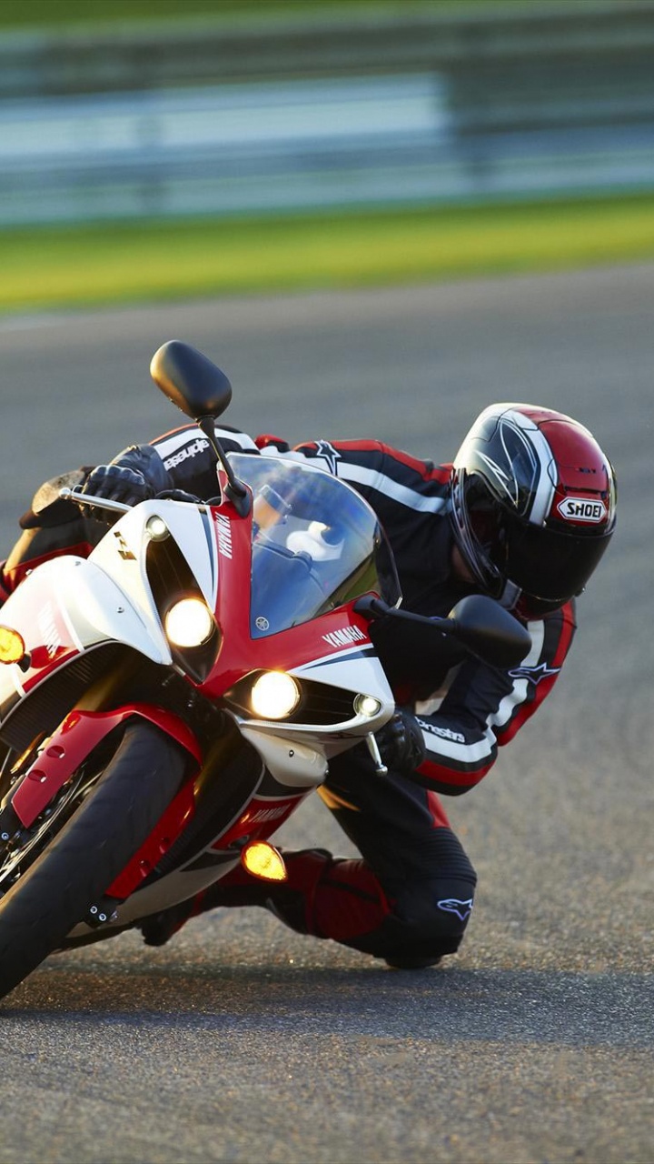 Man in Black and Red Motorcycle Suit Riding on Sports Bike. Wallpaper in 720x1280 Resolution