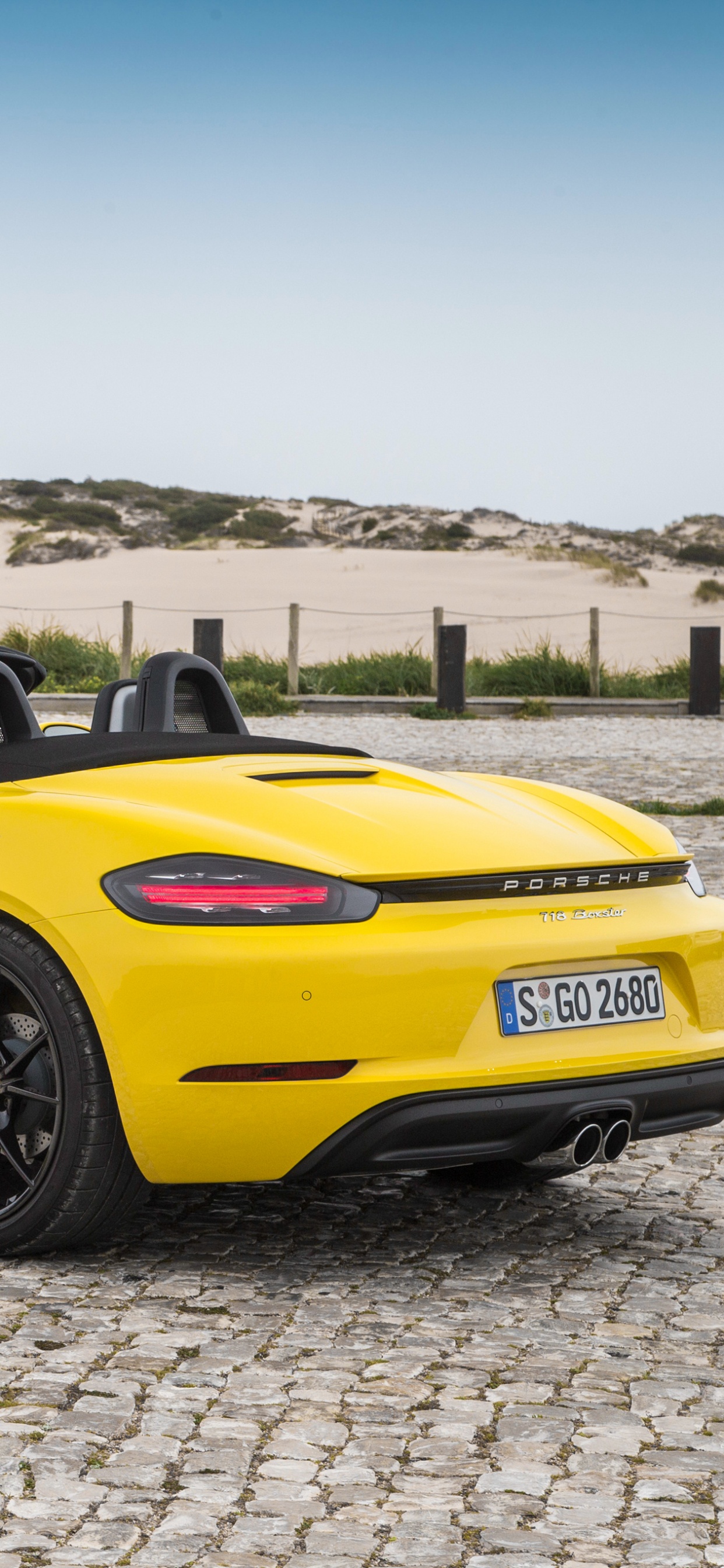 Yellow Porsche 911 on Gray Sand During Daytime. Wallpaper in 1242x2688 Resolution