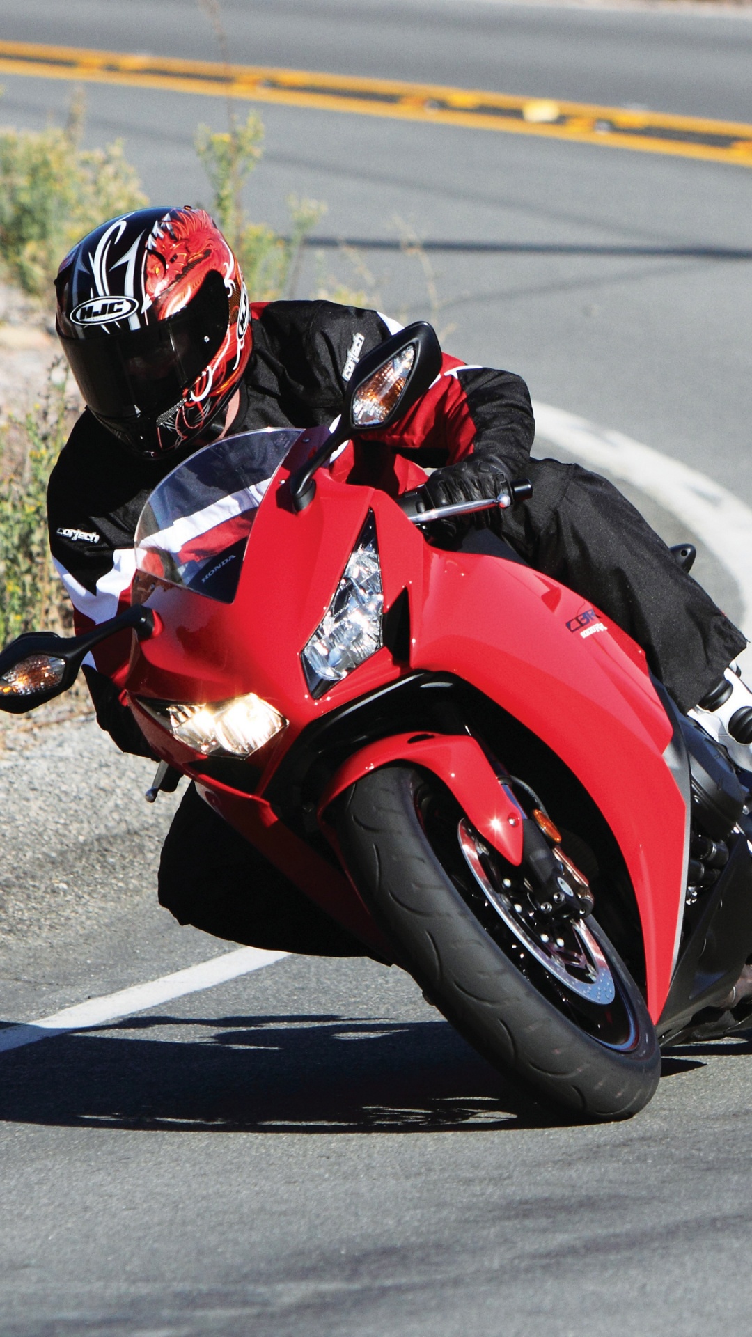 Man in Red and Black Sports Shirt Riding Red Sports Bike on Road During Daytime. Wallpaper in 1080x1920 Resolution