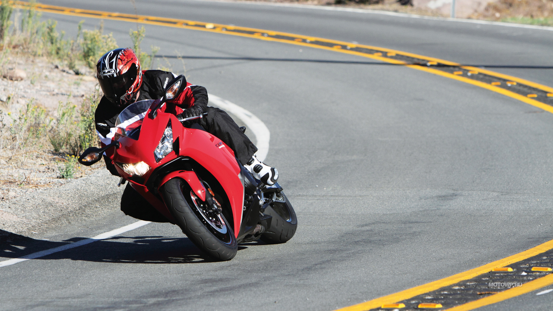 Man in Red and Black Sports Shirt Riding Red Sports Bike on Road During Daytime. Wallpaper in 1920x1080 Resolution