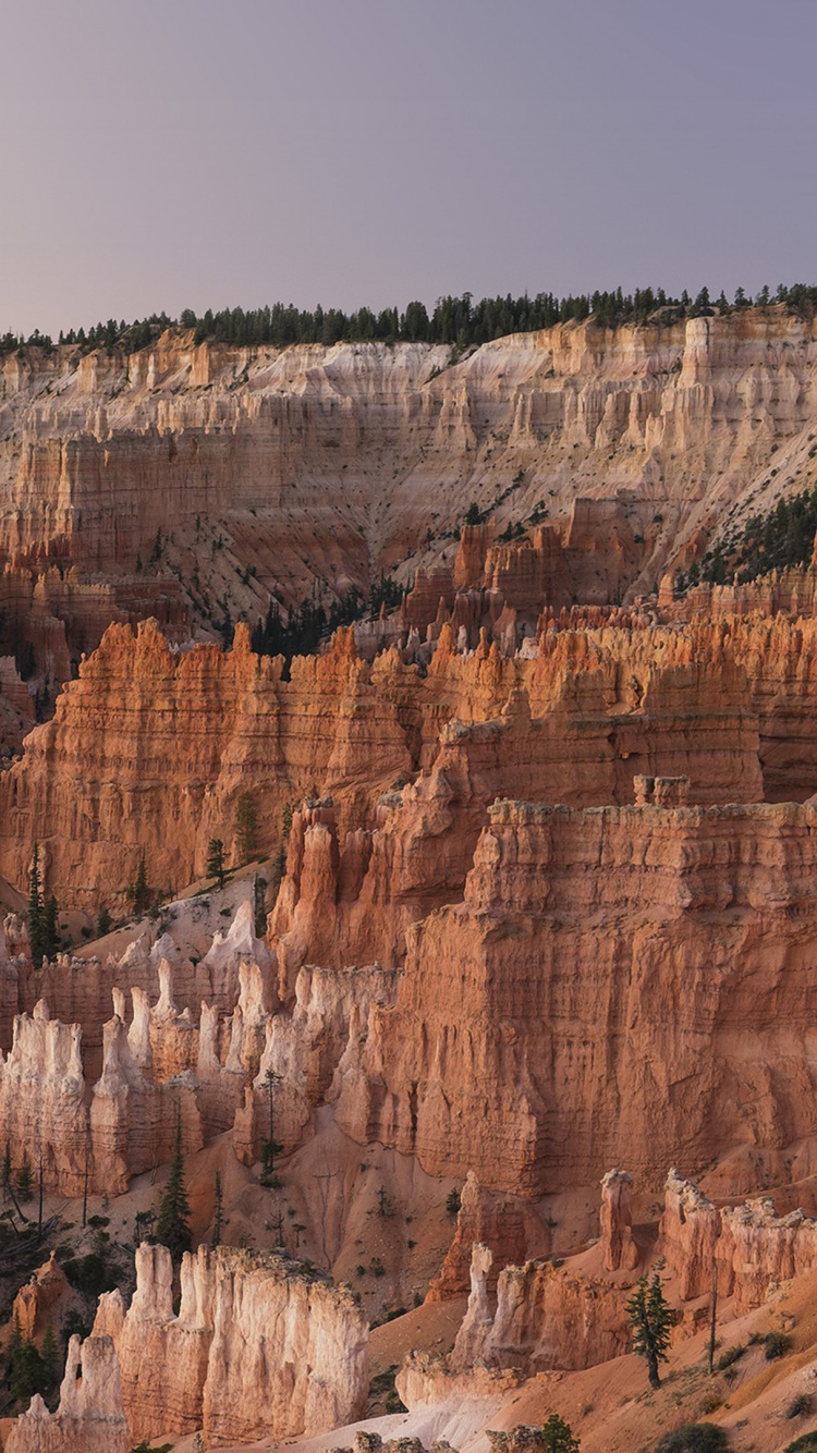 Brown Rocky Mountain Under Blue Sky During Daytime. Wallpaper in 750x1334 Resolution