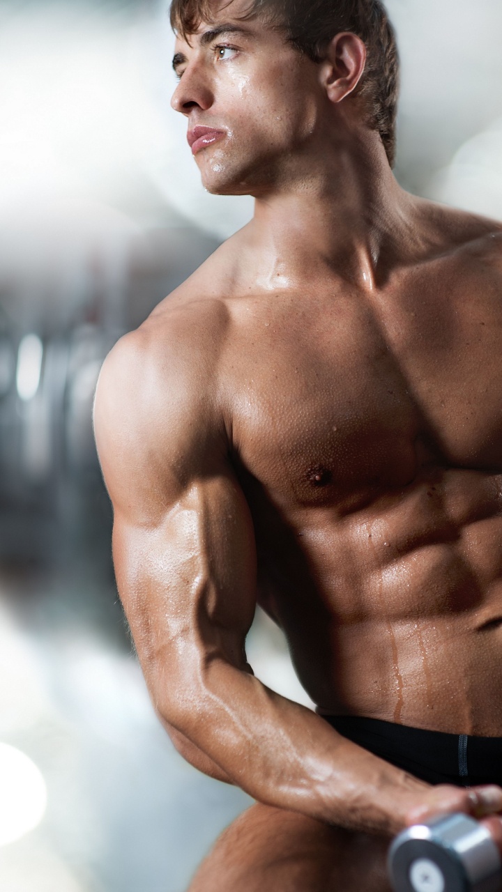 Topless Man in Black Shorts Holding Black Dumbbell. Wallpaper in 720x1280 Resolution