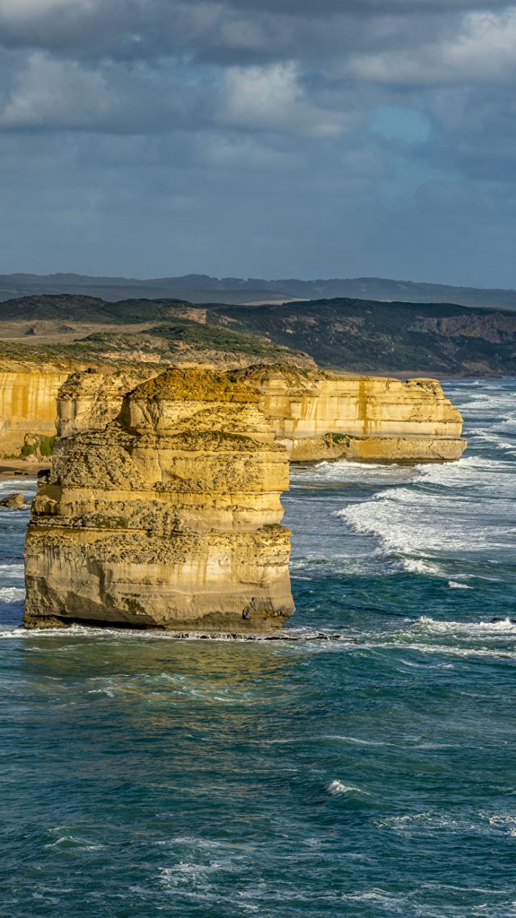 Brown Rock Formation on Sea Under White Clouds During Daytime. Wallpaper in 750x1334 Resolution