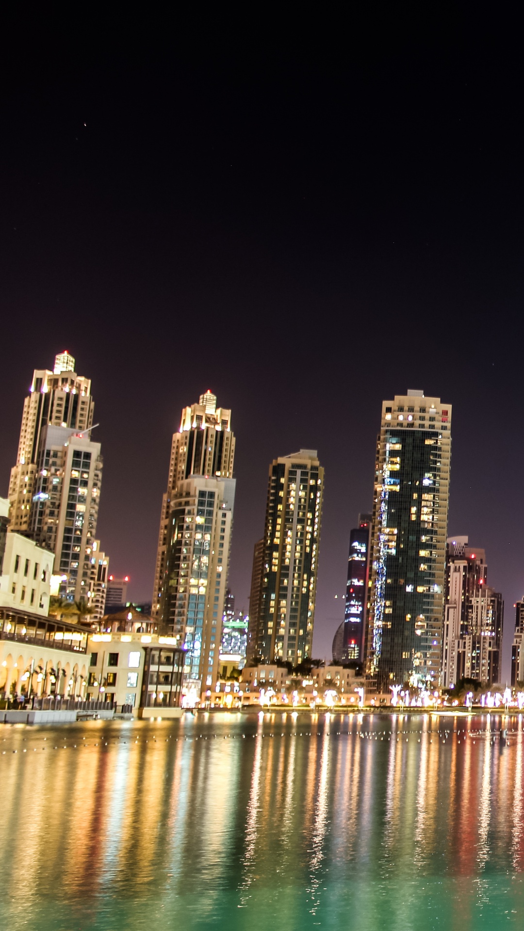 City Skyline Across Body of Water During Night Time. Wallpaper in 1080x1920 Resolution
