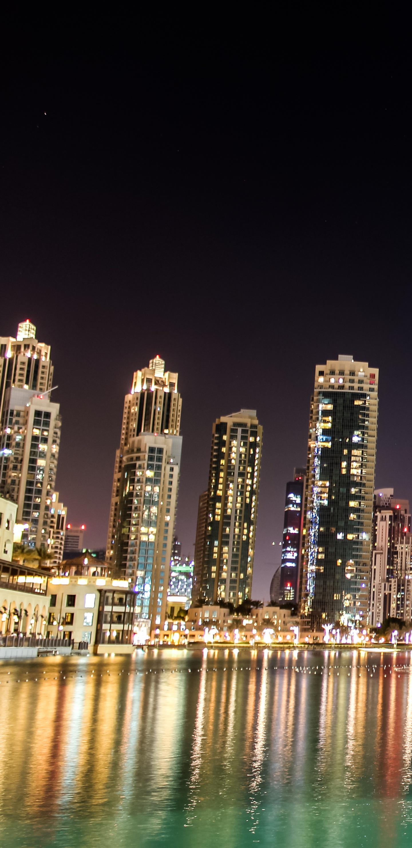 City Skyline Across Body of Water During Night Time. Wallpaper in 1440x2960 Resolution