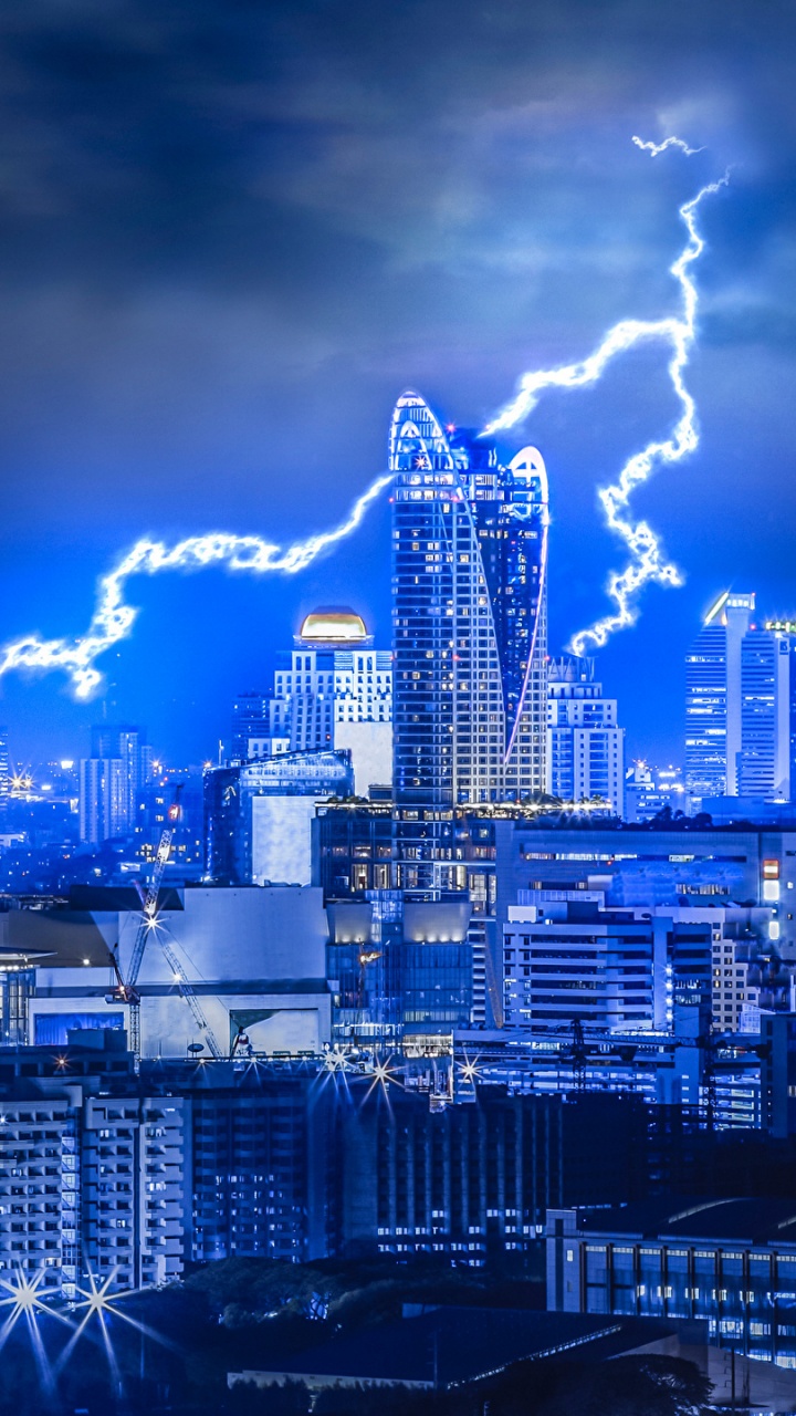 City Skyline Under Blue Sky and White Clouds During Night Time. Wallpaper in 720x1280 Resolution