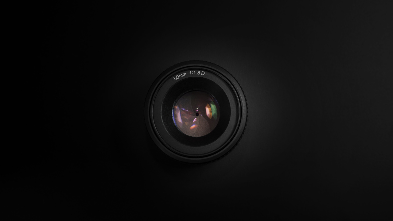 Black Camera Lens on Black Surface. Wallpaper in 1280x720 Resolution