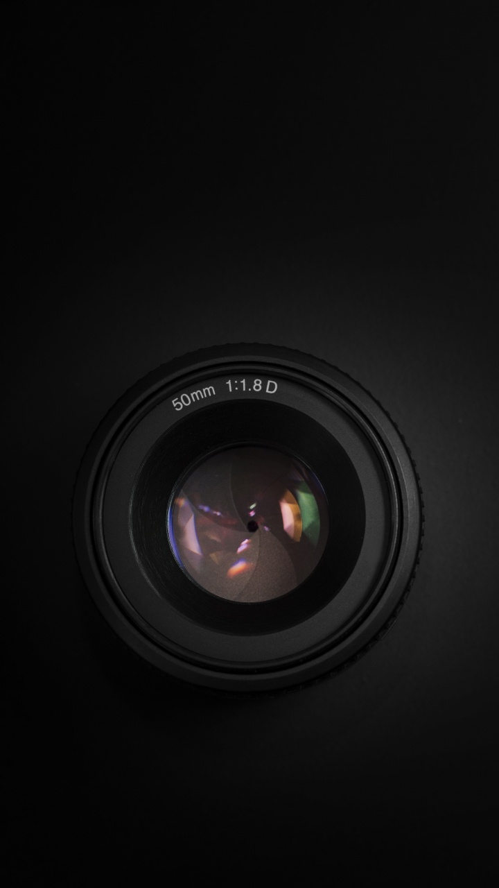 Black Camera Lens on Black Surface. Wallpaper in 720x1280 Resolution