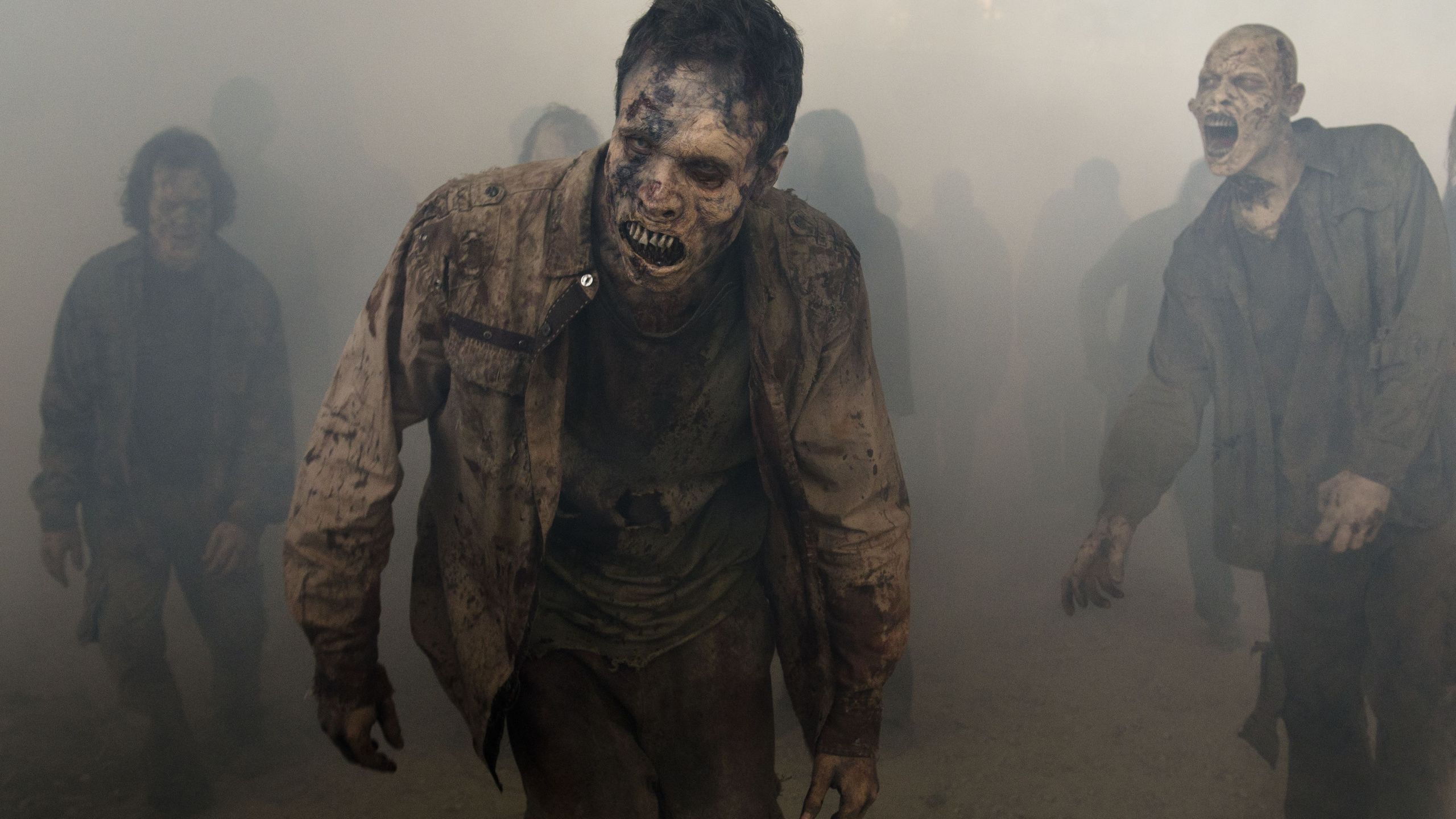 Man in Black and Brown Camouflage Suit. Wallpaper in 2560x1440 Resolution