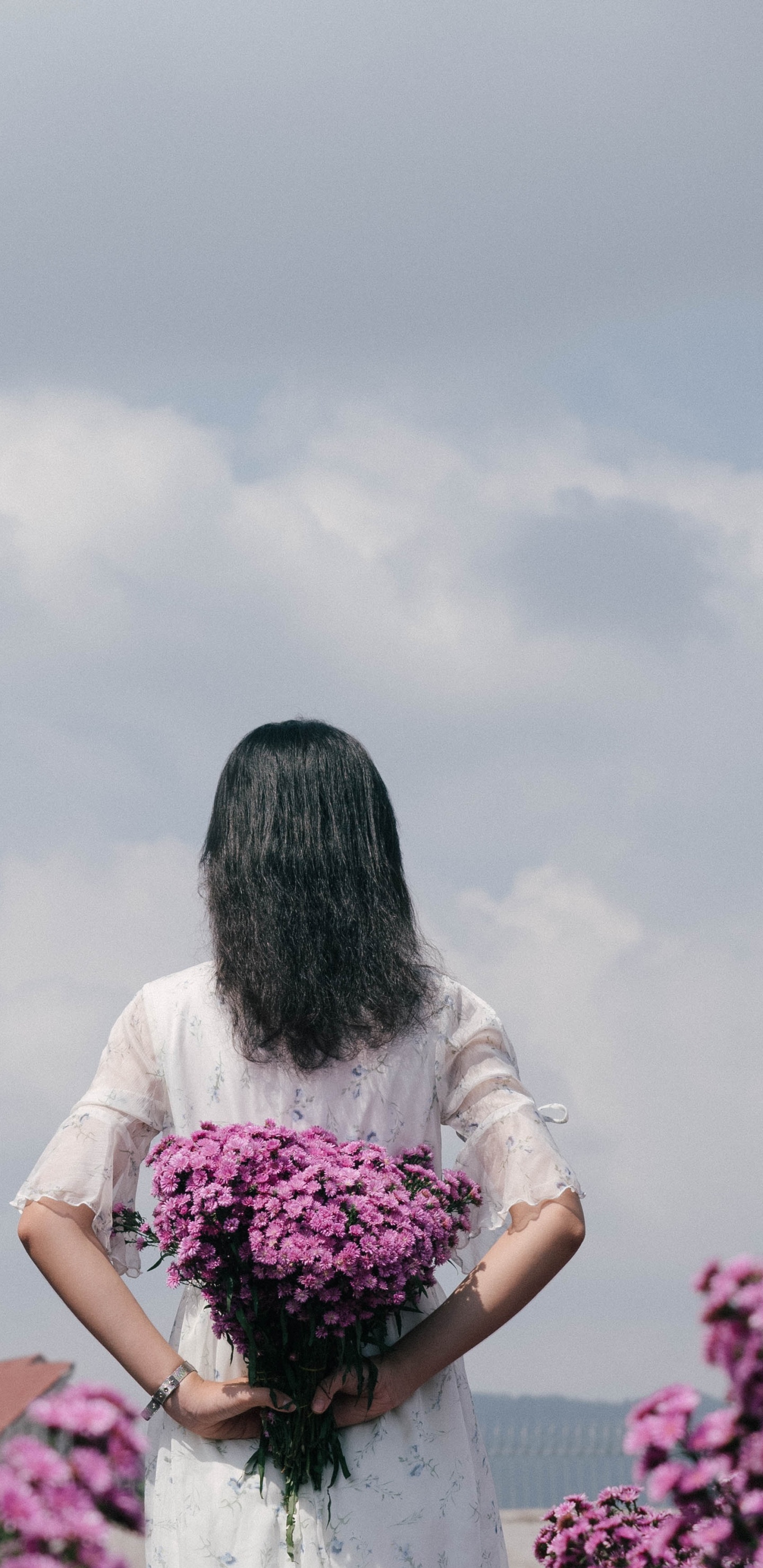 Woman in White Shirt Holding Pink Flower Bouquet. Wallpaper in 1440x2960 Resolution