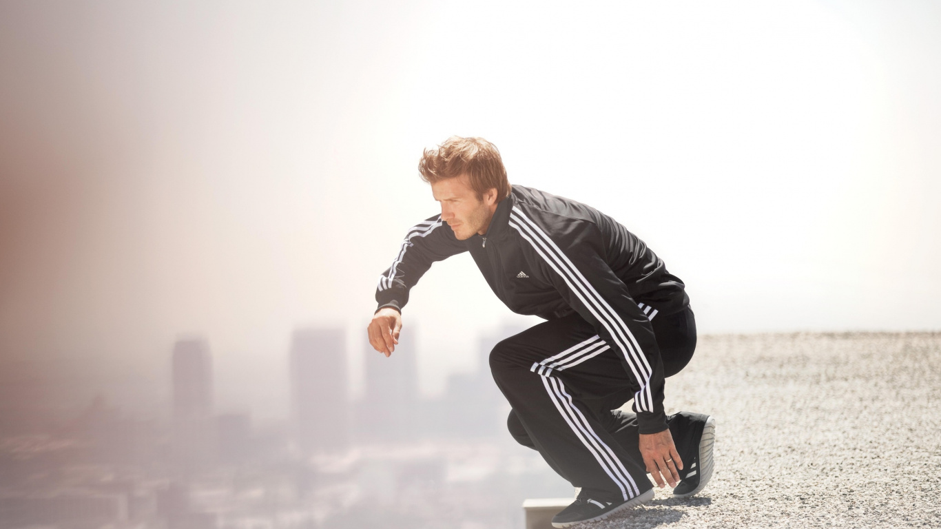 Man in Black Leather Jacket and Black Pants Sitting on White Concrete Bench During Daytime. Wallpaper in 1366x768 Resolution