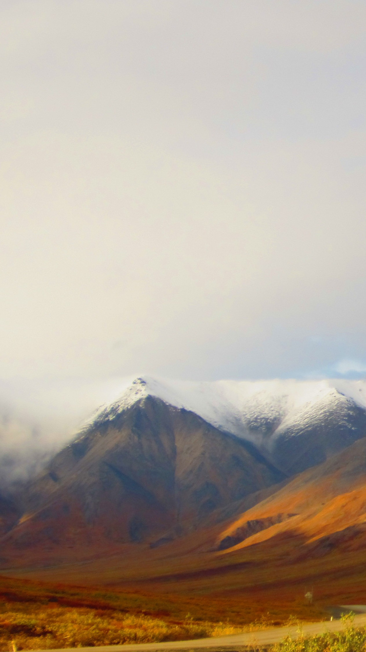 Brown and White Mountains Under White Clouds During Daytime. Wallpaper in 750x1334 Resolution