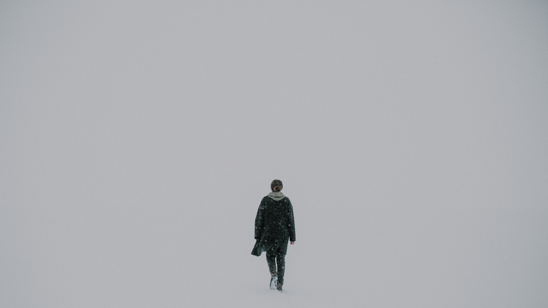 Man in Black Jacket Standing on Snow Covered Ground. Wallpaper in 1920x1080 Resolution