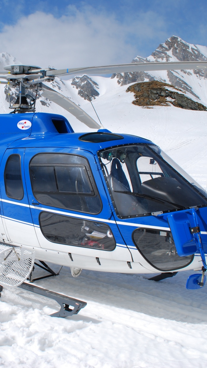 Blue and White Helicopter on Snow Covered Ground During Daytime. Wallpaper in 720x1280 Resolution