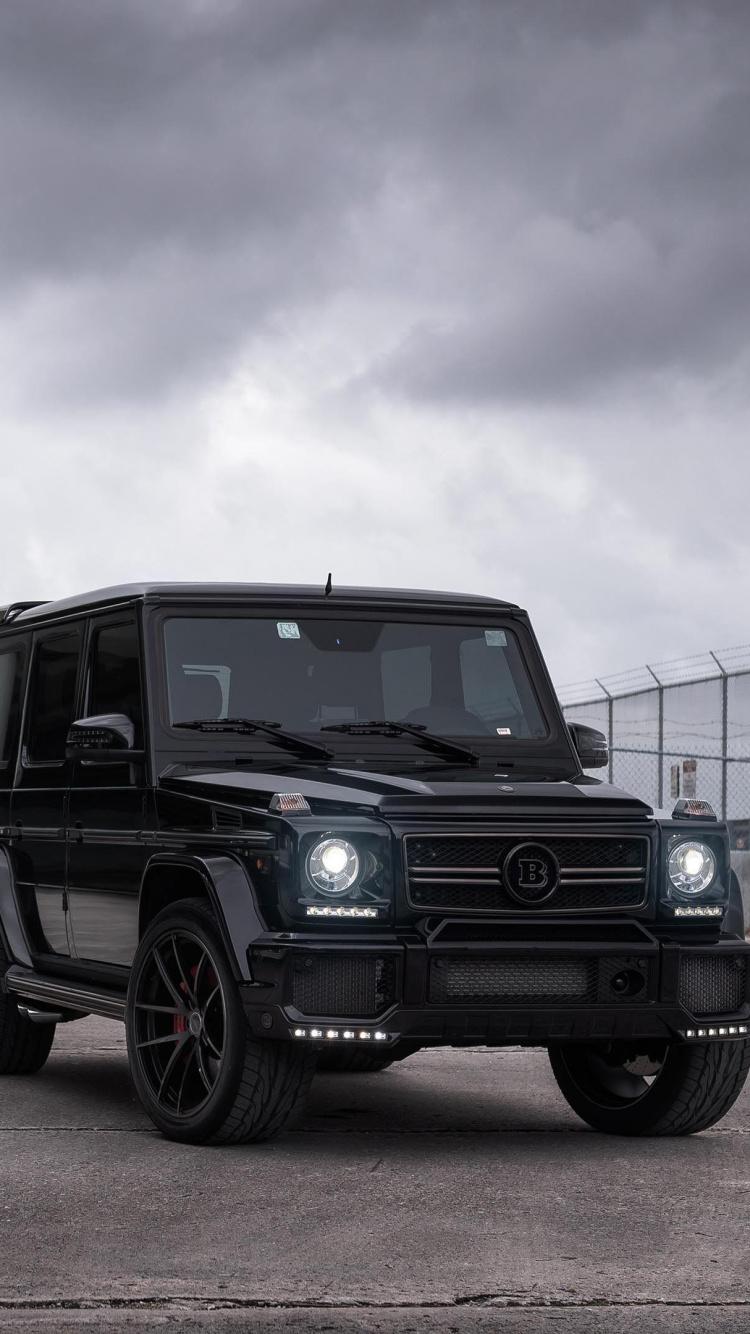 Black Jeep Wrangler Parked Beside Blue and White House Under White Clouds and Blue Sky During. Wallpaper in 750x1334 Resolution