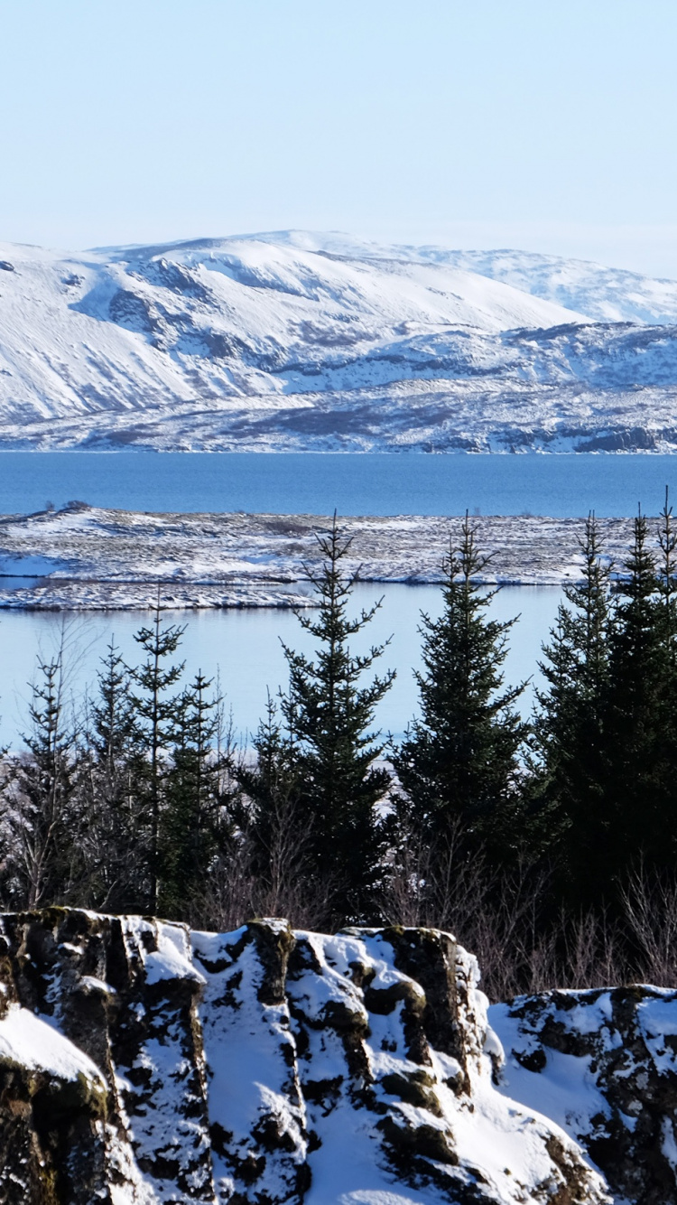 Snow Covered Mountain Near Body of Water During Daytime. Wallpaper in 750x1334 Resolution