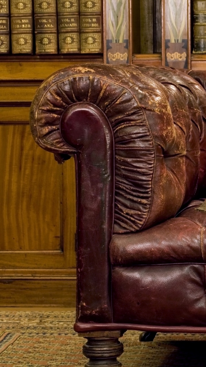 White Book on Brown Leather Couch. Wallpaper in 720x1280 Resolution