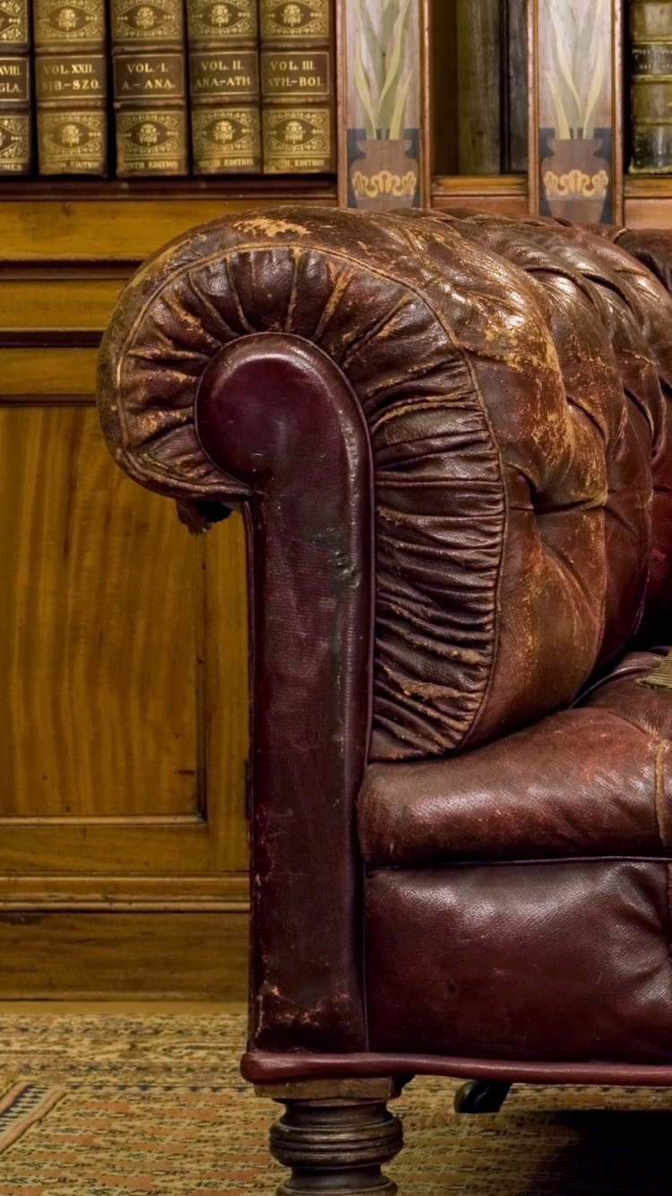 White Book on Brown Leather Couch. Wallpaper in 750x1334 Resolution