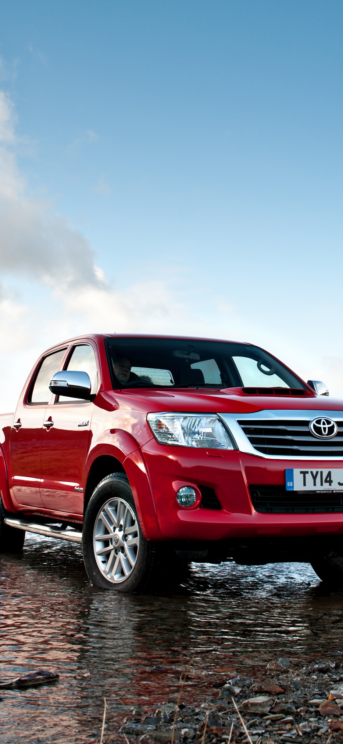 Red and Black Chevrolet Suv on Gray Sand During Daytime. Wallpaper in 1125x2436 Resolution