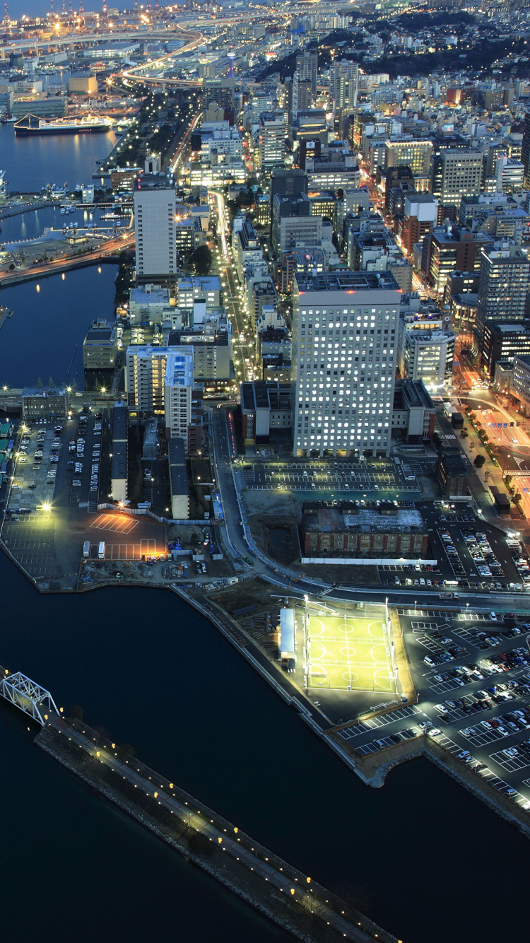 Vista Aérea de Los Edificios de la Ciudad Durante la Noche.. Wallpaper in 750x1334 Resolution