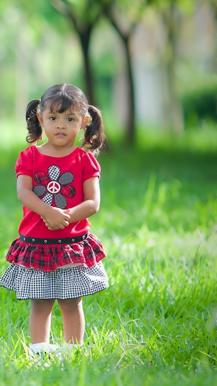 Girl in Red Dress Standing Beside Tree. Wallpaper in 750x1334 Resolution