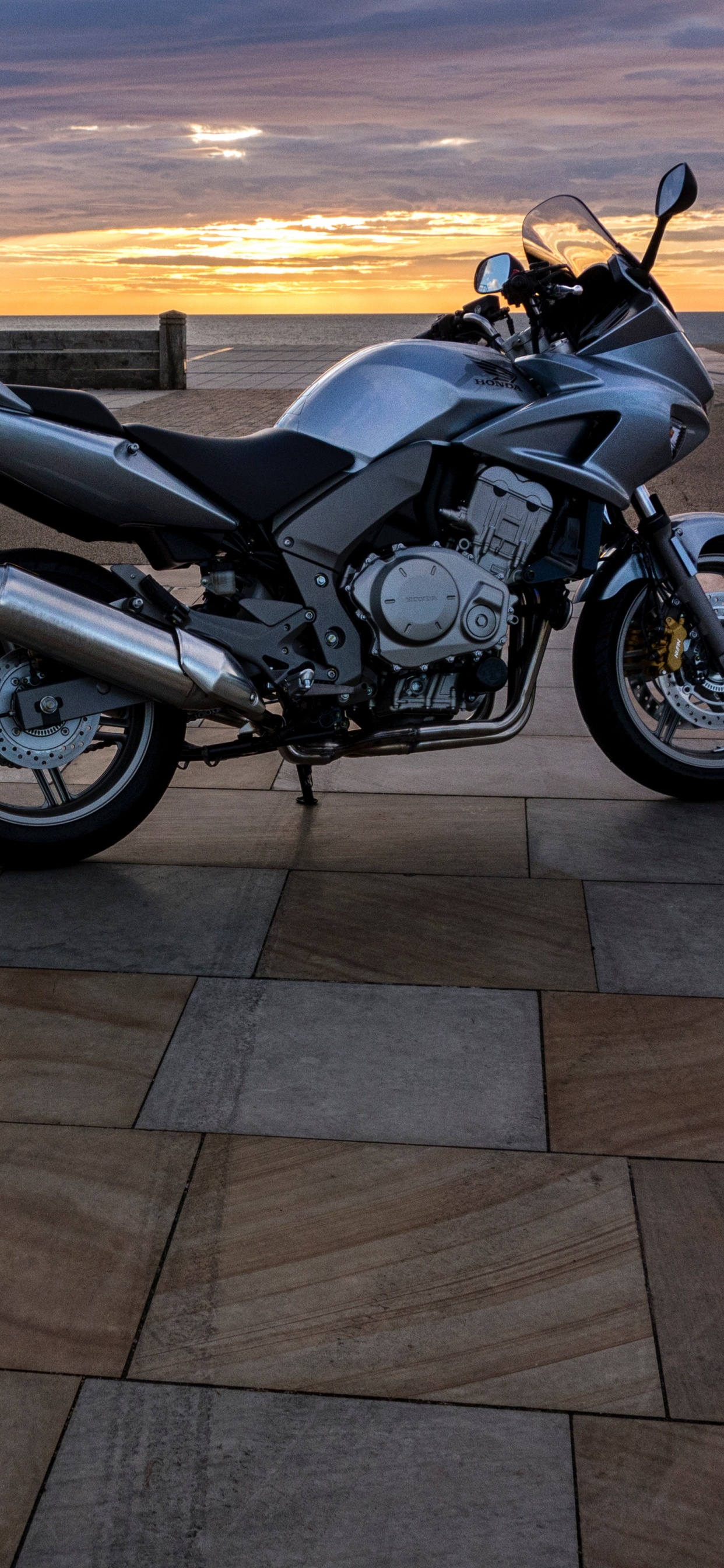 Black and Silver Cruiser Motorcycle on Gray Concrete Road During Sunset. Wallpaper in 1242x2688 Resolution