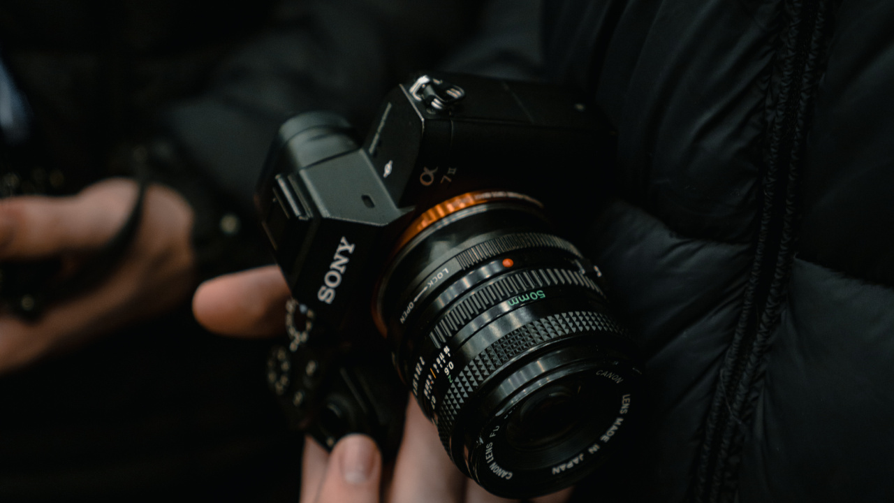 Person Holding Black Dslr Camera. Wallpaper in 1280x720 Resolution