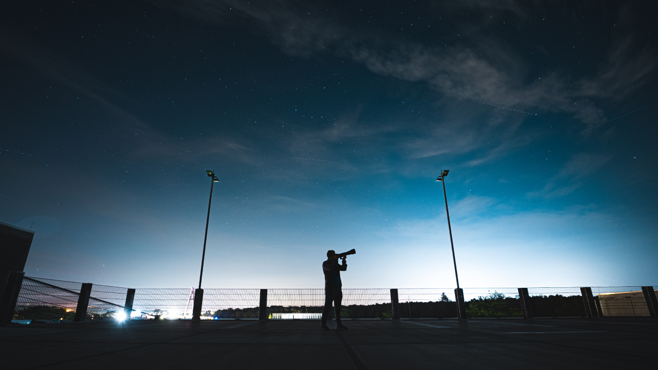 Silhouette of Person Standing on Sidewalk During Night Time. Wallpaper in 1280x720 Resolution