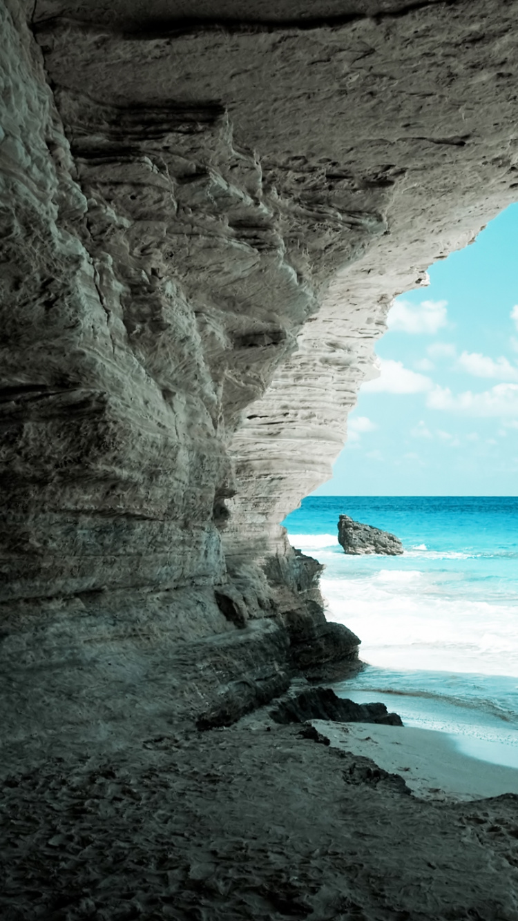 Brown Rocky Mountain Near Sea During Daytime. Wallpaper in 750x1334 Resolution