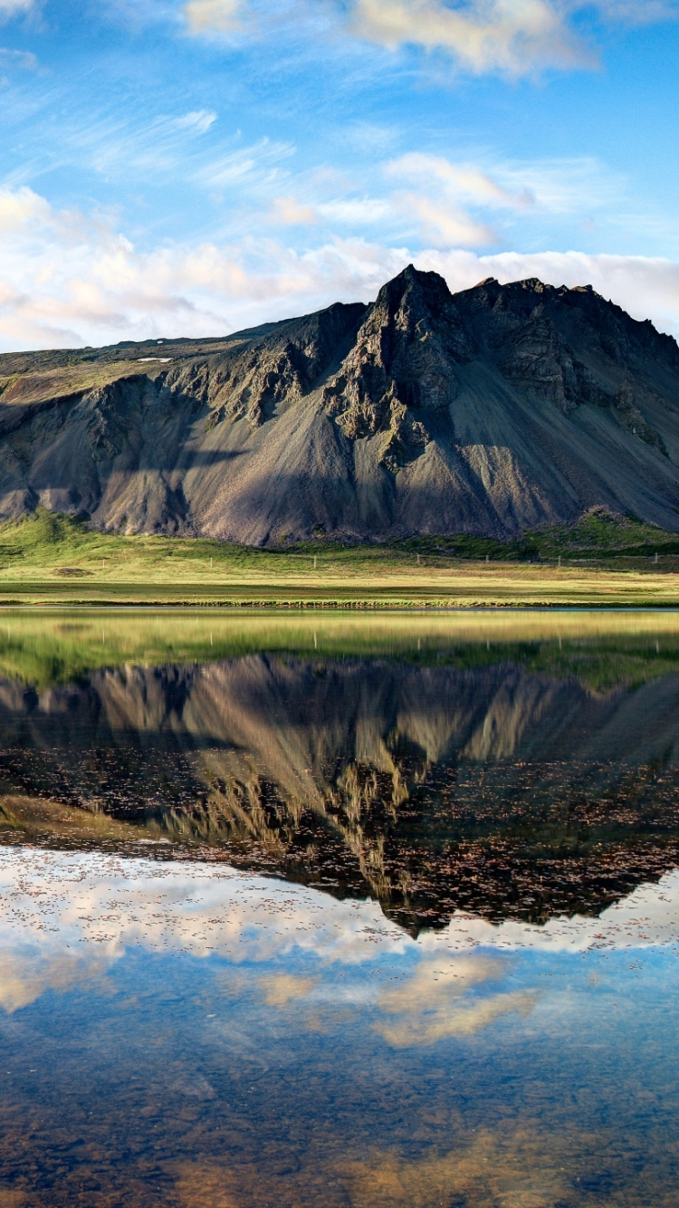 Green and Brown Mountains Beside Lake Under Blue Sky During Daytime. Wallpaper in 750x1334 Resolution