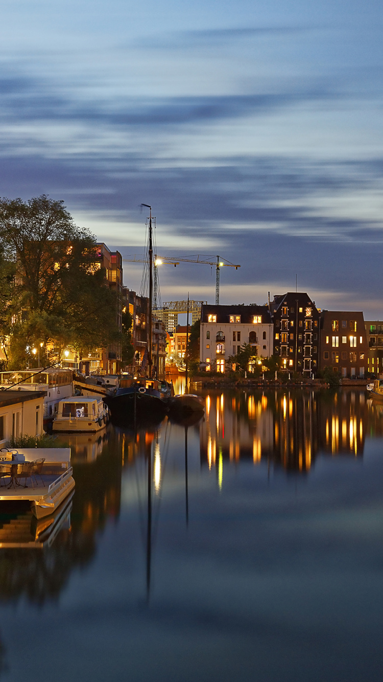 Body of Water Near Green Trees and Buildings During Daytime. Wallpaper in 750x1334 Resolution