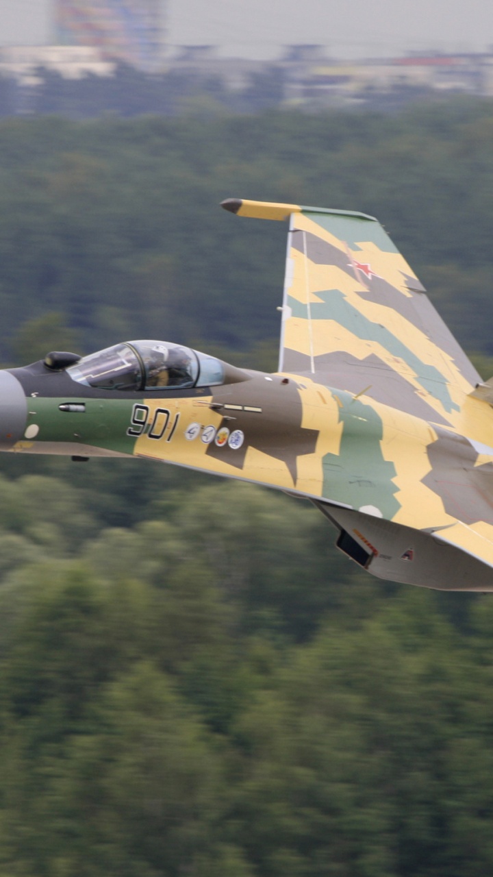 Green and Yellow Fighter Jet Flying Over Green Trees During Daytime. Wallpaper in 720x1280 Resolution