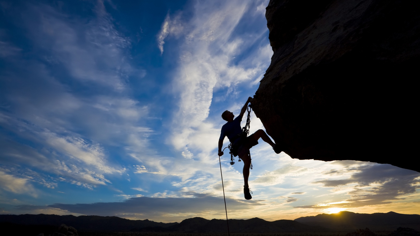 Man in Black Jacket and Black Pants Climbing on Brown Rock Mountain During Daytime. Wallpaper in 1366x768 Resolution